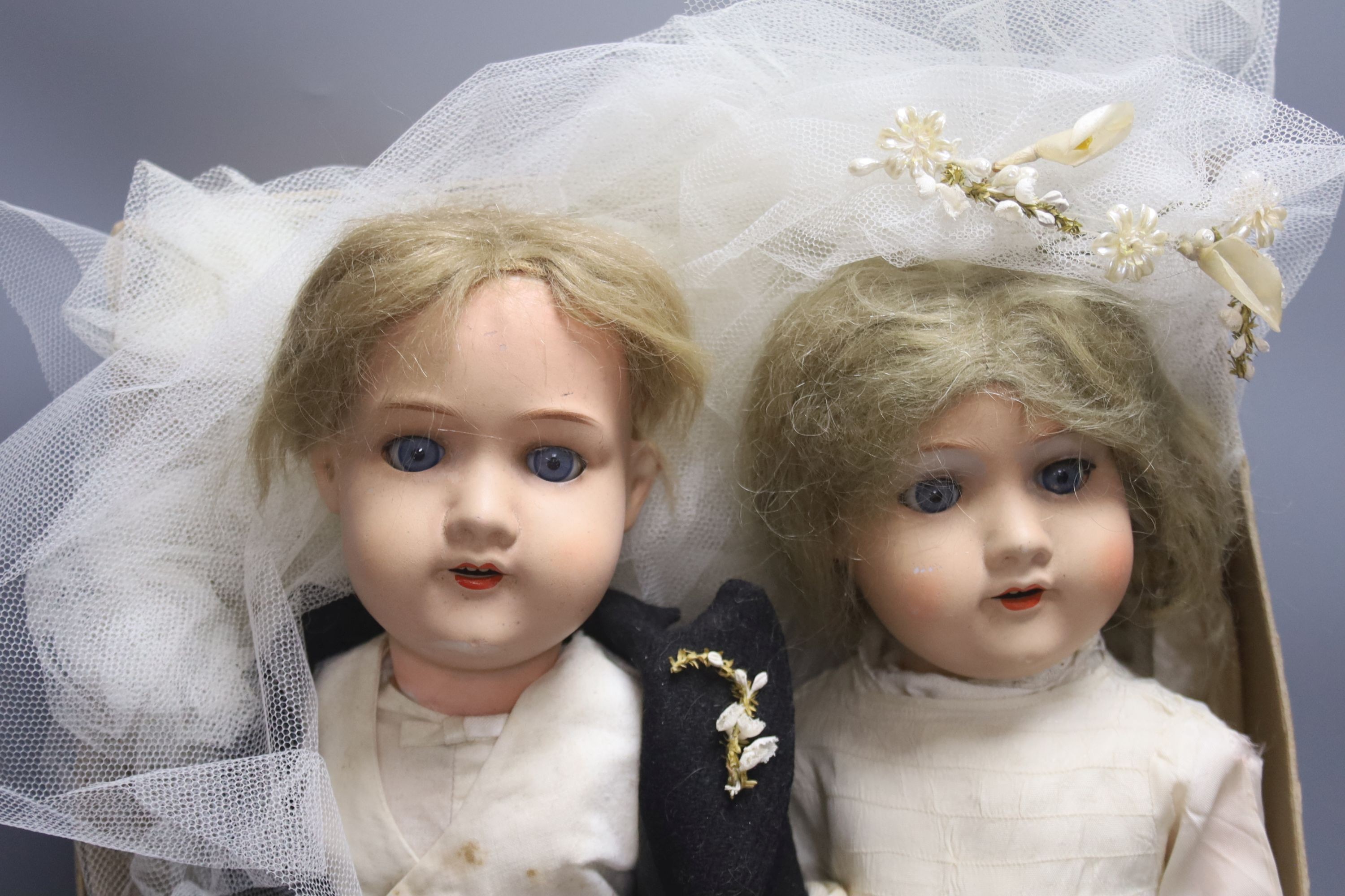 A pair of Armand Marseille 390 bisque head groom and bride dolls, tallest 50cm